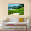 Golf field with green, lake, sand and hole 17 flag Multi Panel Canvas Wall Art