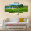 Golf field with green, lake, sand and hole 17 flag Multi Panel Canvas Wall Art