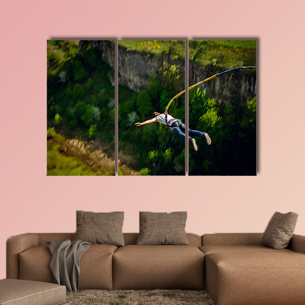 An extreme sportsman jumps on a rope from a great height Multi panel canvas wall art