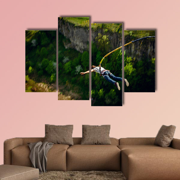 An extreme sportsman jumps on a rope from a great height Multi panel canvas wall art