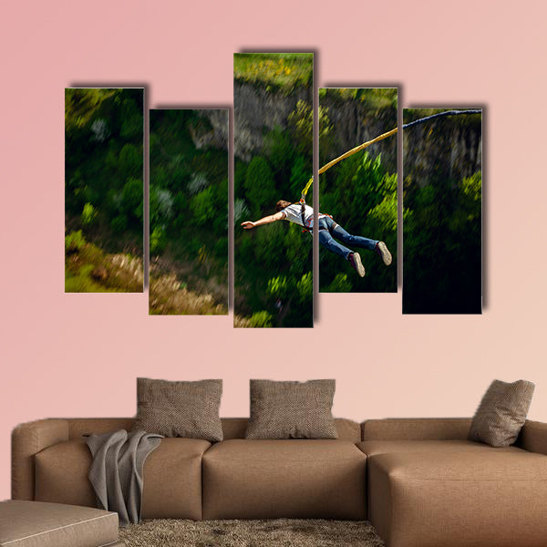 An extreme sportsman jumps on a rope from a great height Multi panel canvas wall art