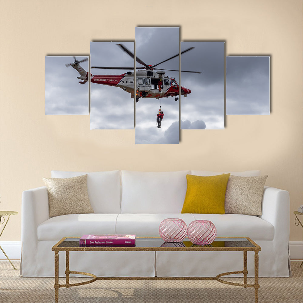 A coastguard helicopter dropping off mountain rescue team members multi panel canvas wall art