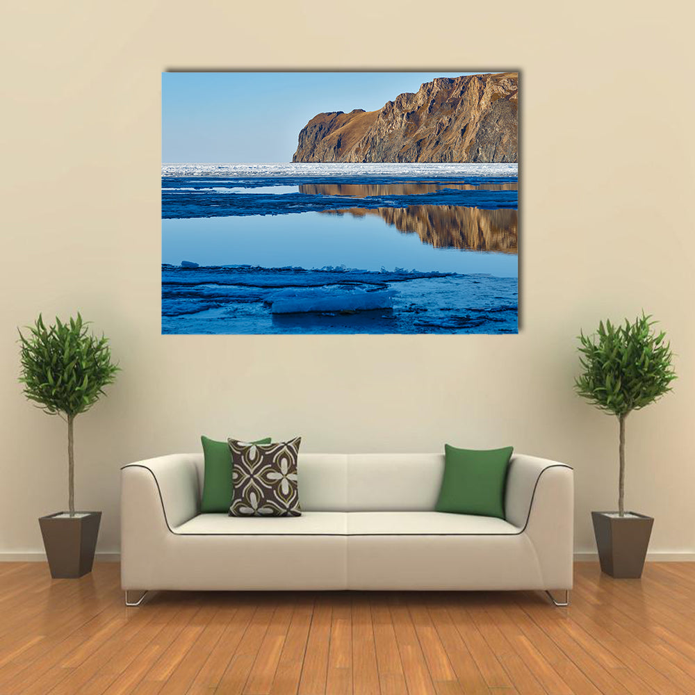 Red rock at Baikal Lake with melting ice Multi panel canvas wall art