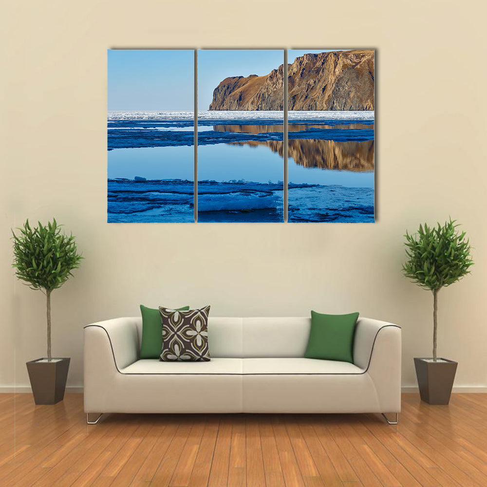 Red rock at Baikal Lake with melting ice Multi panel canvas wall art