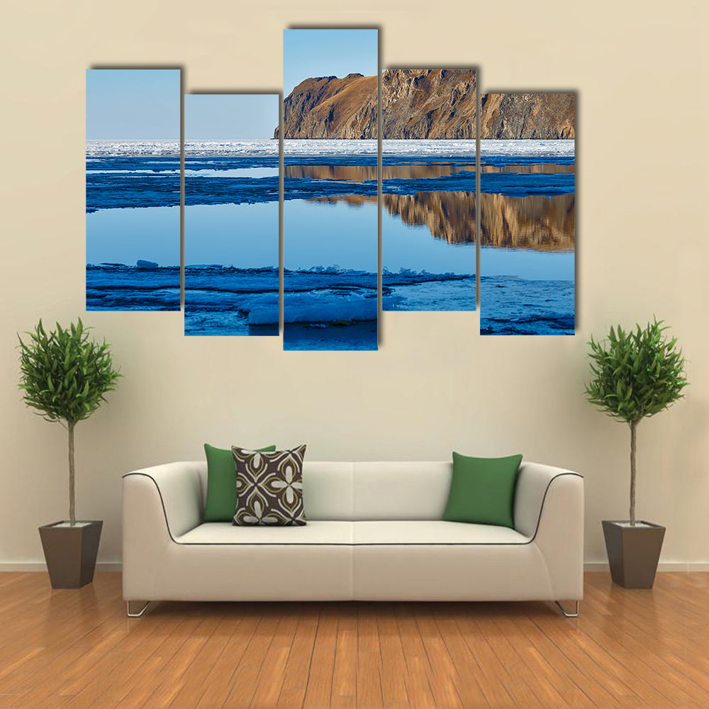 Red rock at Baikal Lake with melting ice Multi panel canvas wall art