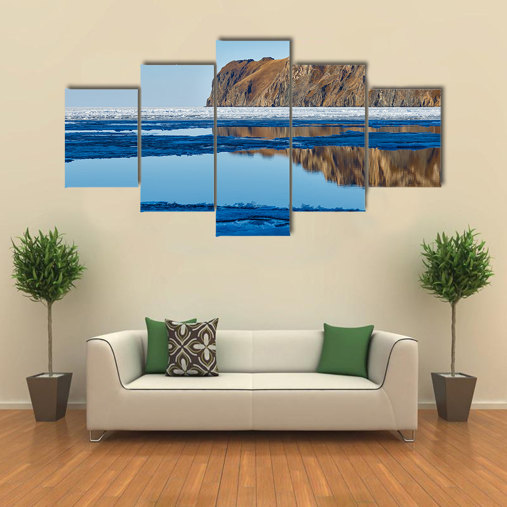 Red rock at Baikal Lake with melting ice Multi panel canvas wall art