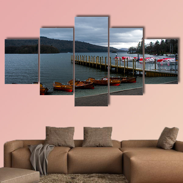 A row of wooden boats, next to a pier and speed boats, in canvas wall art