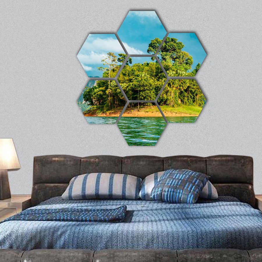 Small island with tropical trees on a lake with mountains hexagonal canvas wall art