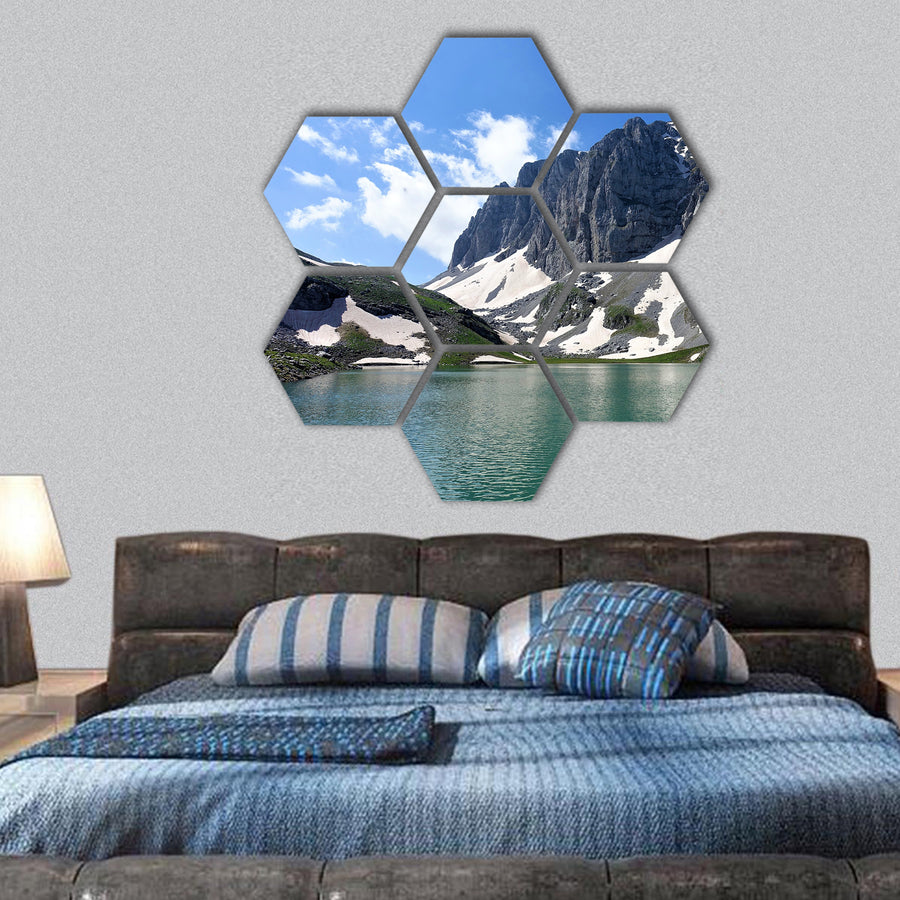 Astraka peak raises behind alpine glacier lake hexagonal canvas wall art