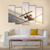 Commercial airliner flying in high sky multi panel canvas wall art