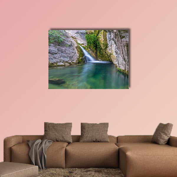 A small picturesque waterfall in a cozy mountain lagoon Multi panel canvas wall art