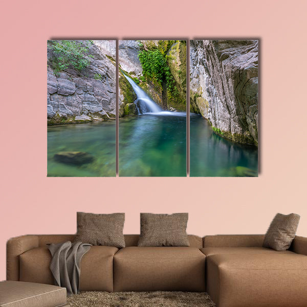 A small picturesque waterfall in a cozy mountain lagoon Multi panel canvas wall art