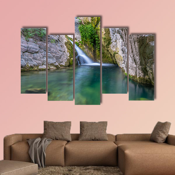 A small picturesque waterfall in a cozy mountain lagoon Multi panel canvas wall art