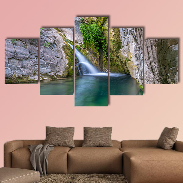 A small picturesque waterfall in a cozy mountain lagoon Multi panel canvas wall art