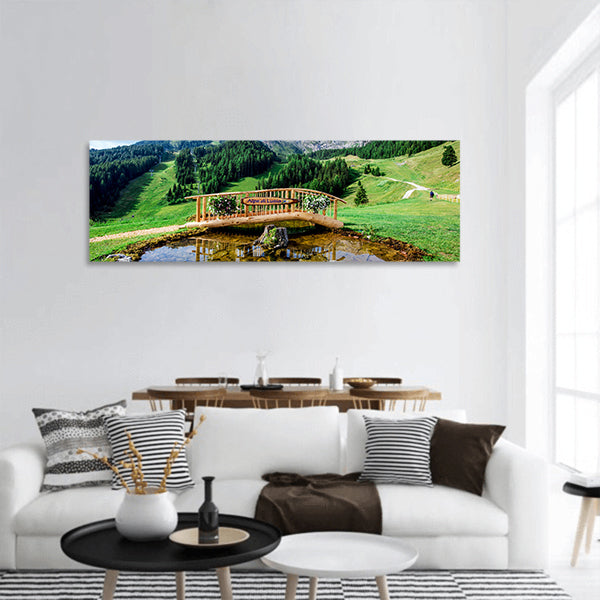 Small wooden bridge with a pond panoramic canvas wall art