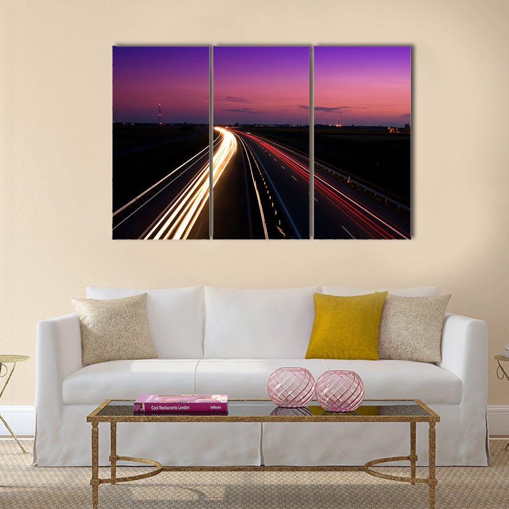 Cars speeding on a highway Multi Panel Canvas Wall Art