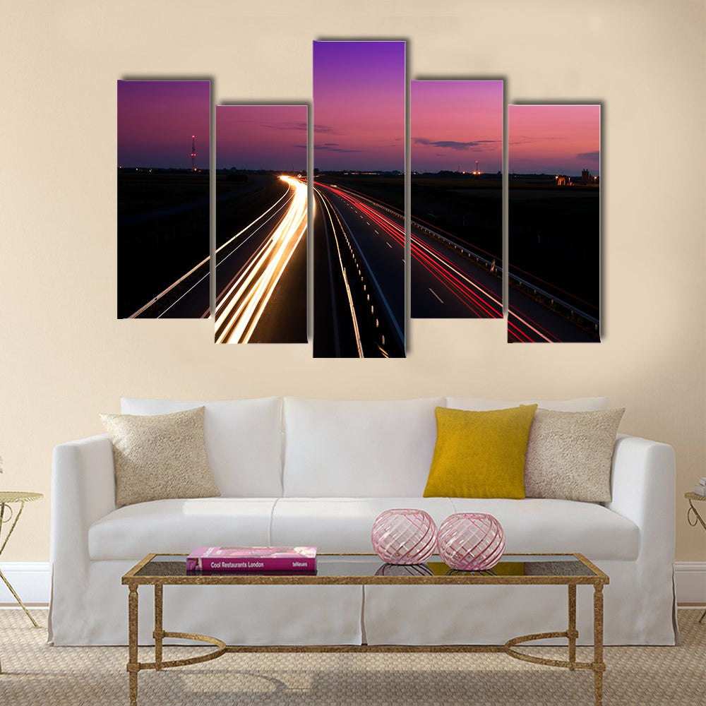 Cars speeding on a highway Multi Panel Canvas Wall Art