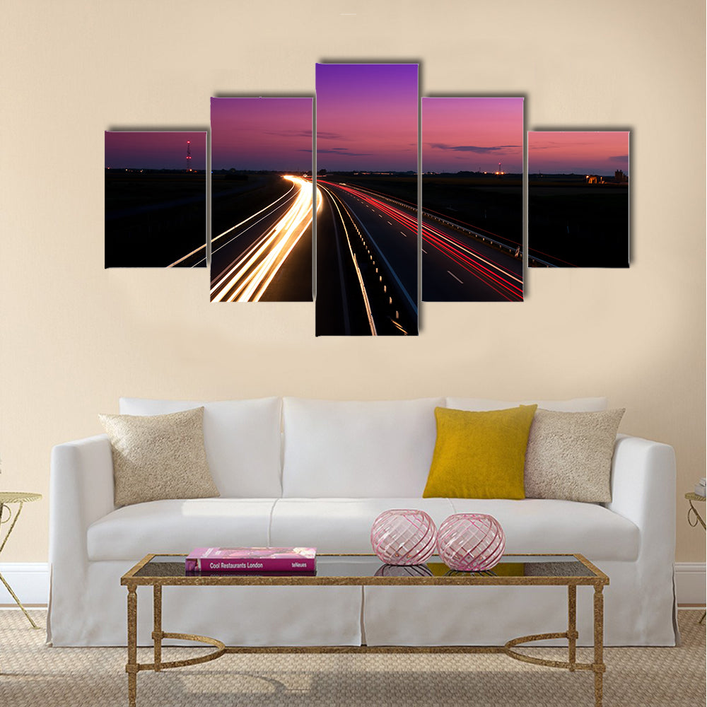 Cars speeding on a highway Multi Panel Canvas Wall Art
