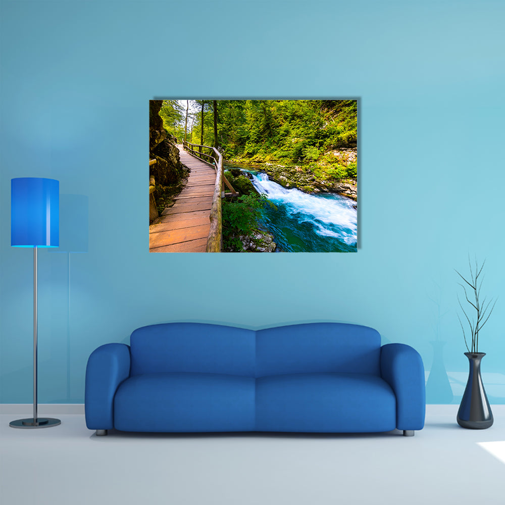 A river near the Bled lake with wooden tourist paths and wild trees Multi Panel Canvas Wall Art