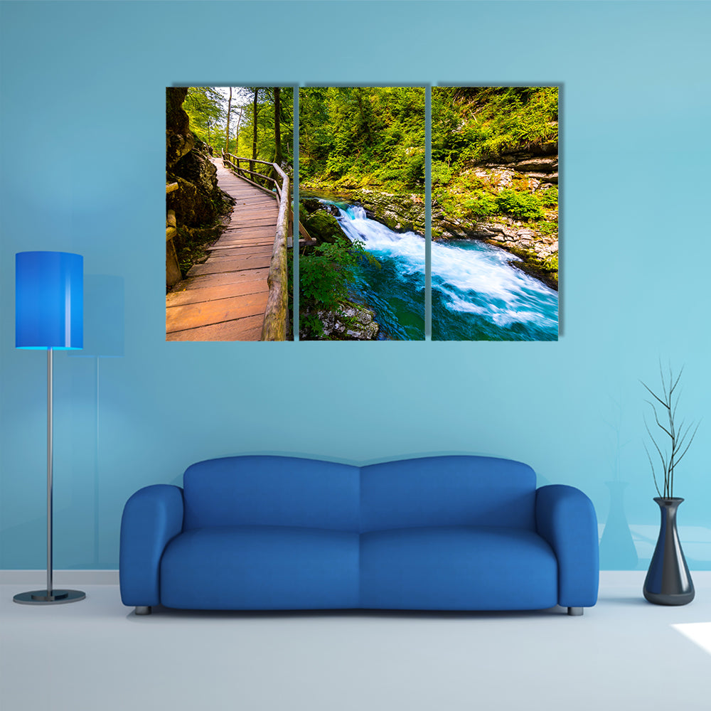 A river near the Bled lake with wooden tourist paths and wild trees Multi Panel Canvas Wall Art
