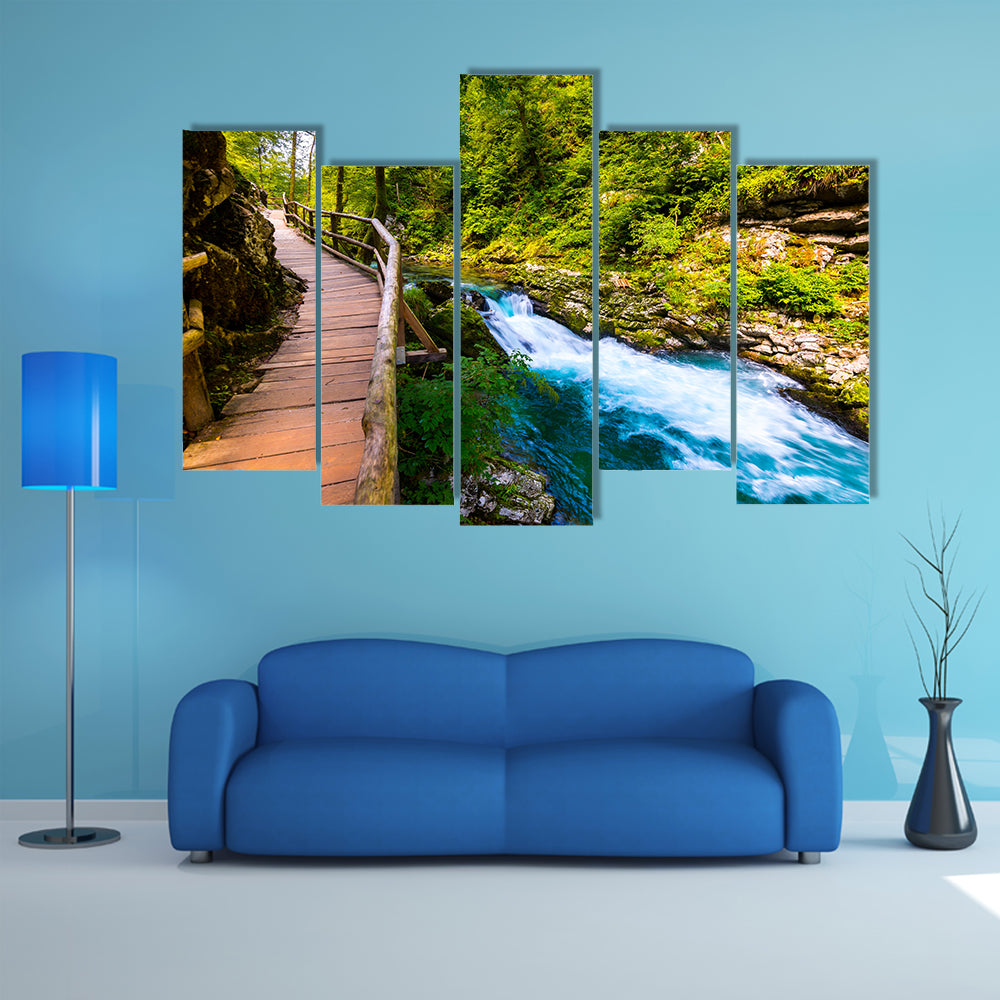 A river near the Bled lake with wooden tourist paths and wild trees Multi Panel Canvas Wall Art
