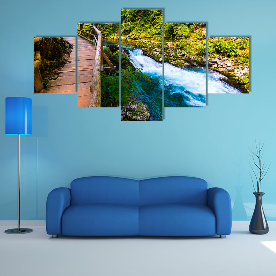A river near the Bled lake with wooden tourist paths and wild trees Multi Panel Canvas Wall Art