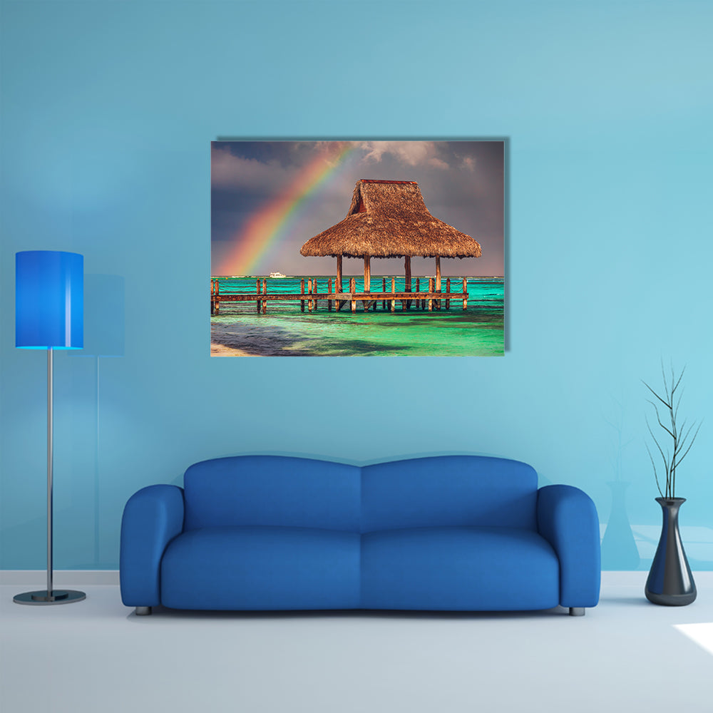 The rainbow over the wooden water villa in Cap Cana, Dominican Republic Multi Panel Canvas Wall Art