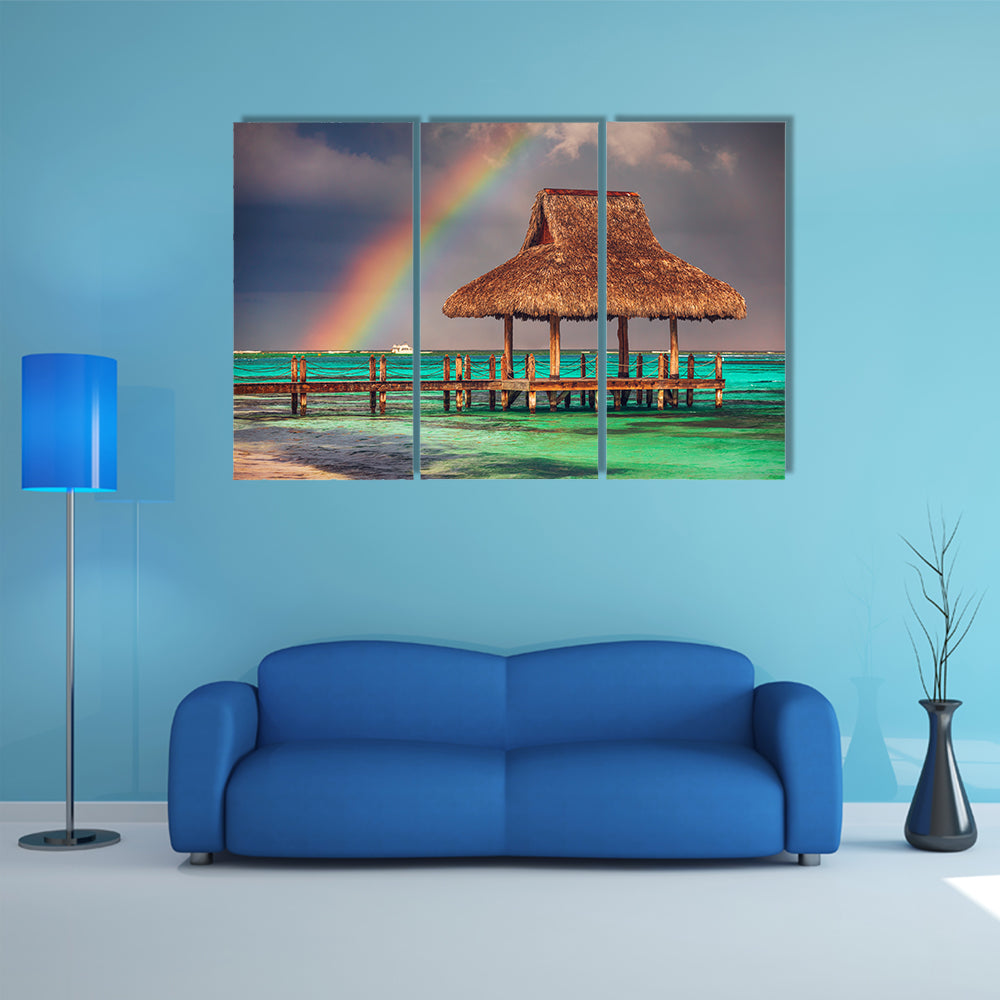 The rainbow over the wooden water villa in Cap Cana, Dominican Republic Multi Panel Canvas Wall Art