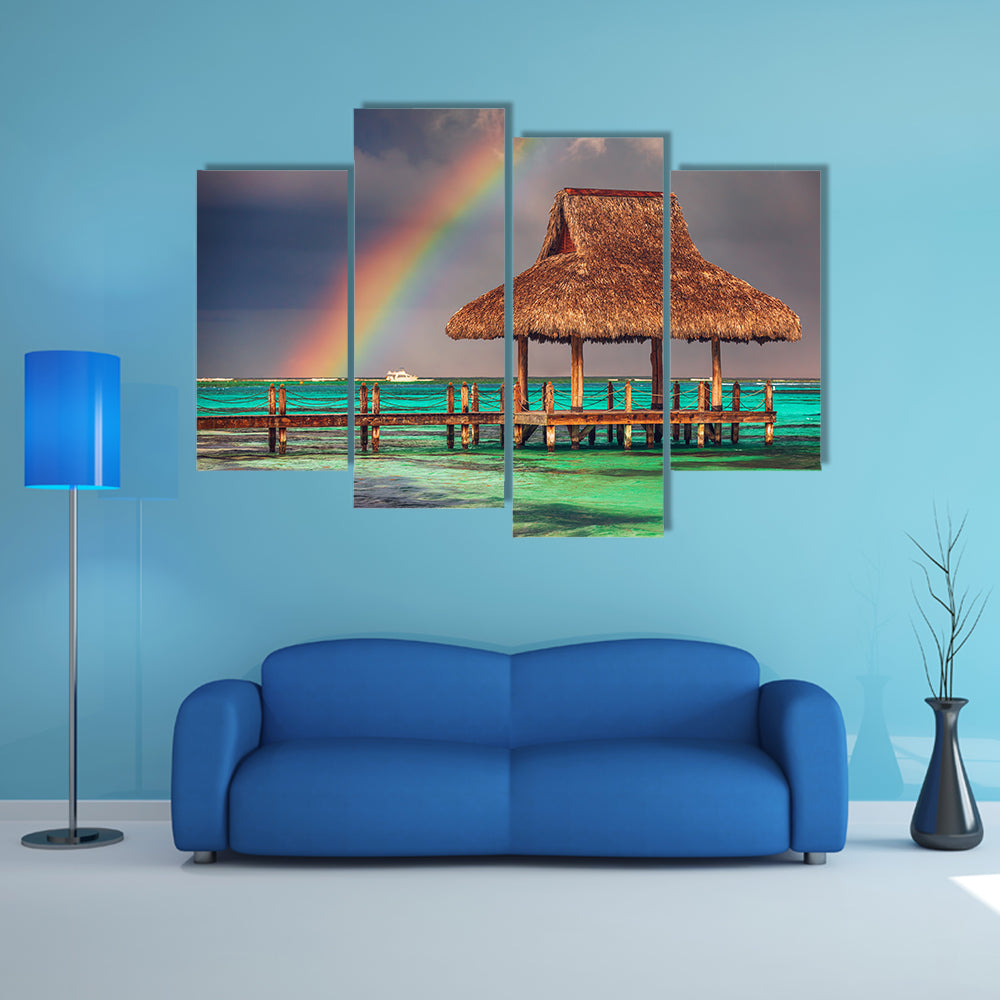 The rainbow over the wooden water villa in Cap Cana, Dominican Republic Multi Panel Canvas Wall Art