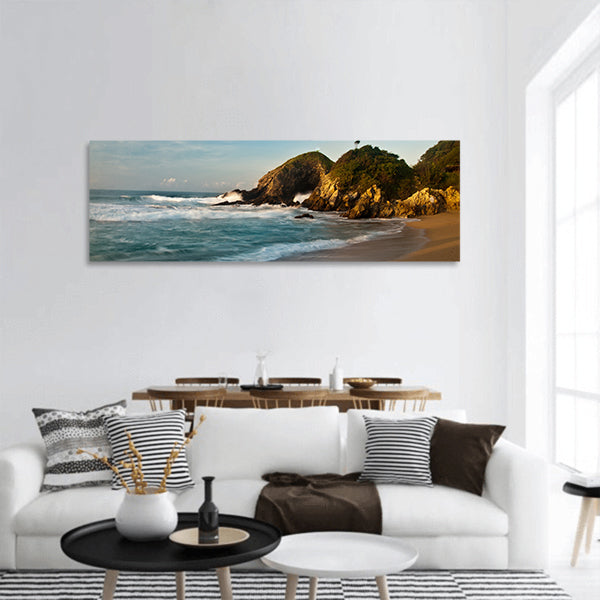 Sandy beach with rocks at sunrise Panoramic Canvas Wall Art