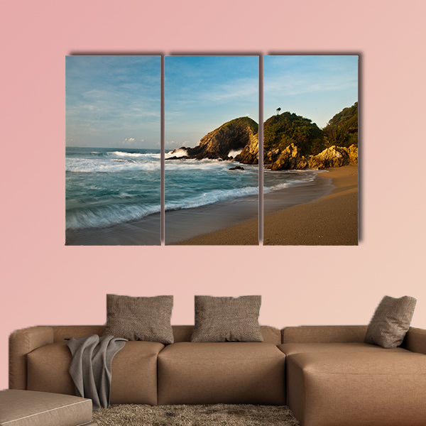 Sandy beach with rocks at sunrise multi panel canvas wall art