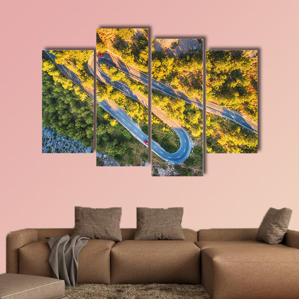 Aerial view of mountain curve road with cars, green forest at sunset wall art