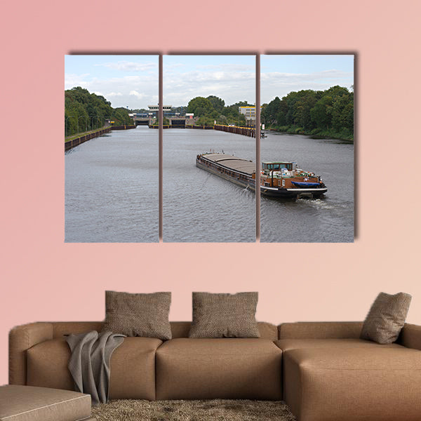 A barge on a canal moving towards a canal lock multi panel canvas wall art