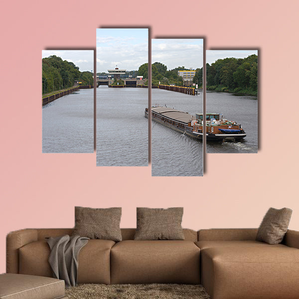 A barge on a canal moving towards a canal lock multi panel canvas wall art