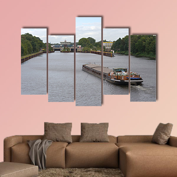 A barge on a canal moving towards a canal lock multi panel canvas wall art