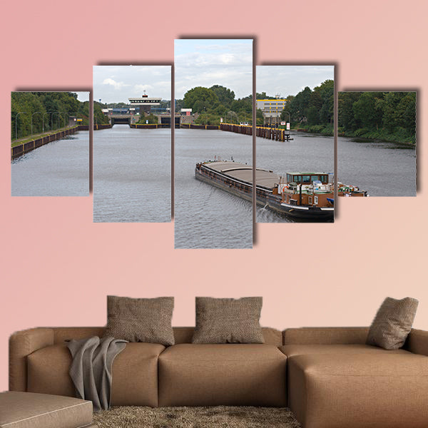 A barge on a canal moving towards a canal lock multi panel canvas wall art