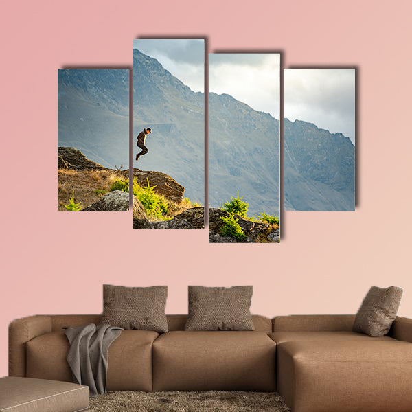 Young man jumping on Queenstown hill multi panel canvas wall art