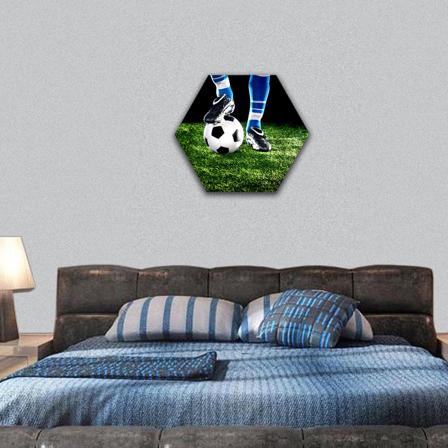 soccer ball with his feet on the football field hexagonal canvas wall art