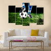 Soccer ball with his feet on the football field Multi panel canvas wall art