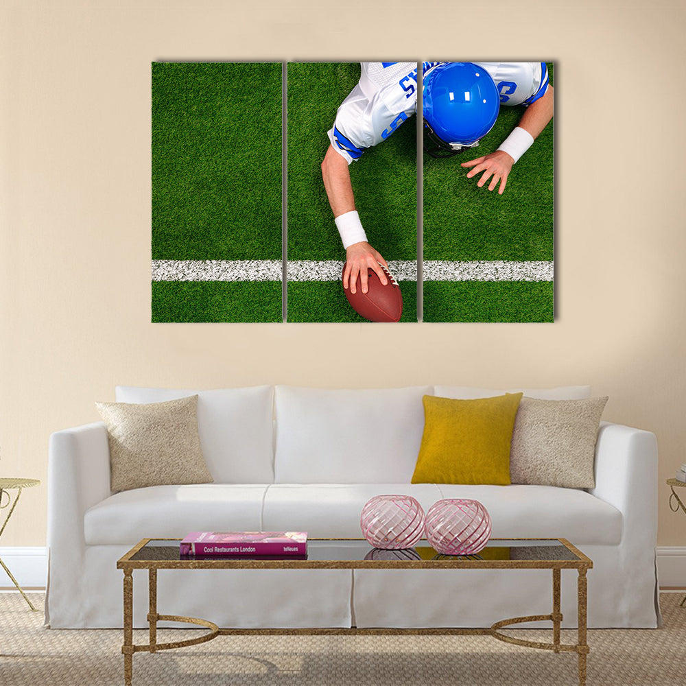 Photo of an American football player making a one handed touchdown Multi panel canvas wall art