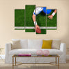 Photo of an American football player making a one handed touchdown Multi panel canvas wall art