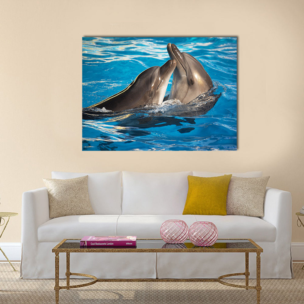Pair of dolphins dancing in light-blue water Multi Panel Canvas Wall Art