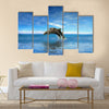 Two Beautiful Dolphins jumping on sea multi panel canvas wall art