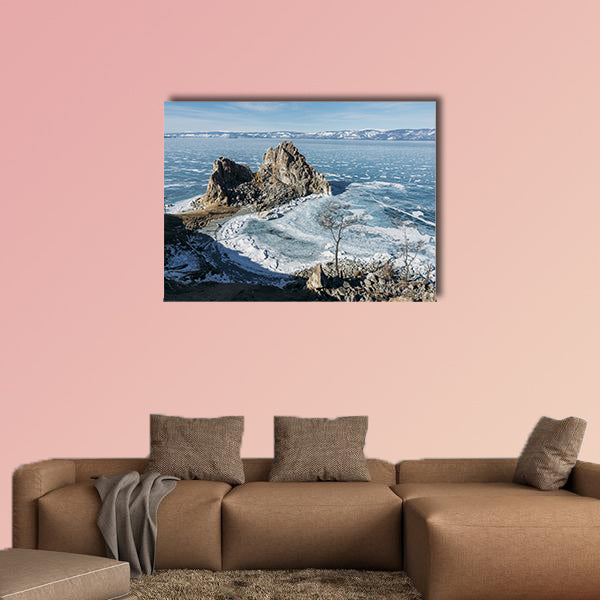View of rock formations on lake shore over water canvas wall art