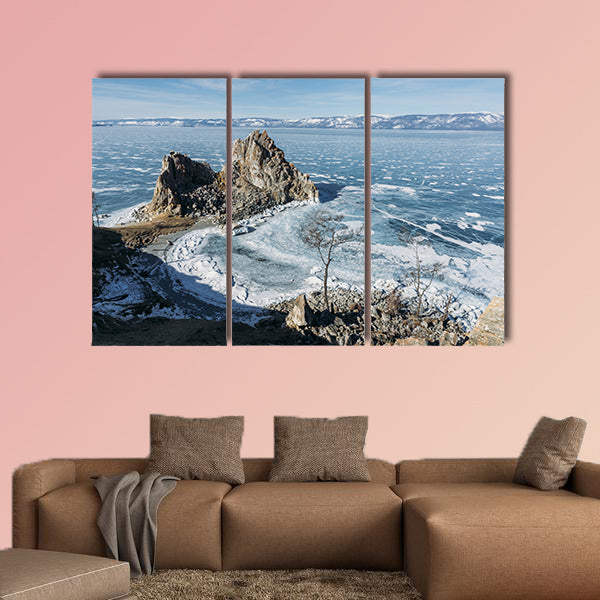 View of rock formations on lake shore over water canvas wall art