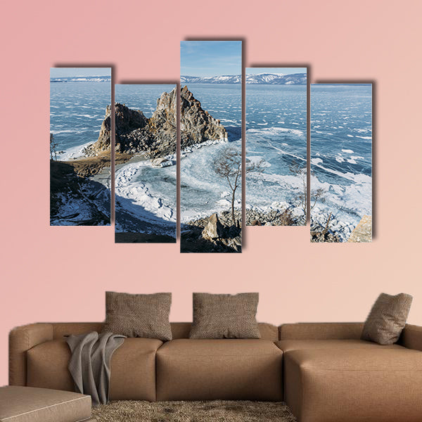 View of rock formations on lake shore over water canvas wall art