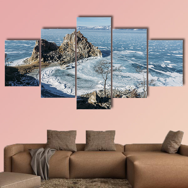 View of rock formations on lake shore over water canvas wall art