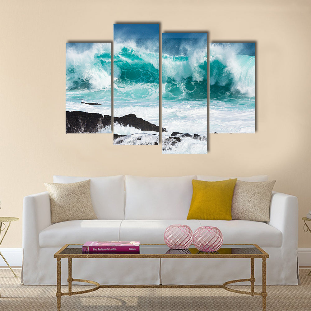 Turquoise rolling wave slaming on the rocks of the coastline Multi Panel Canvas Wall Art