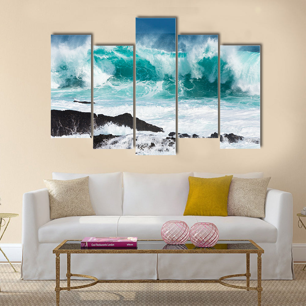Turquoise rolling wave slaming on the rocks of the coastline Multi Panel Canvas Wall Art