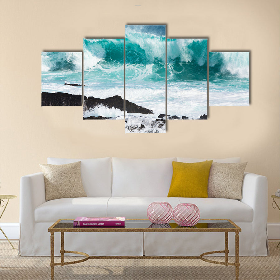 Turquoise rolling wave slaming on the rocks of the coastline Multi Panel Canvas Wall Art